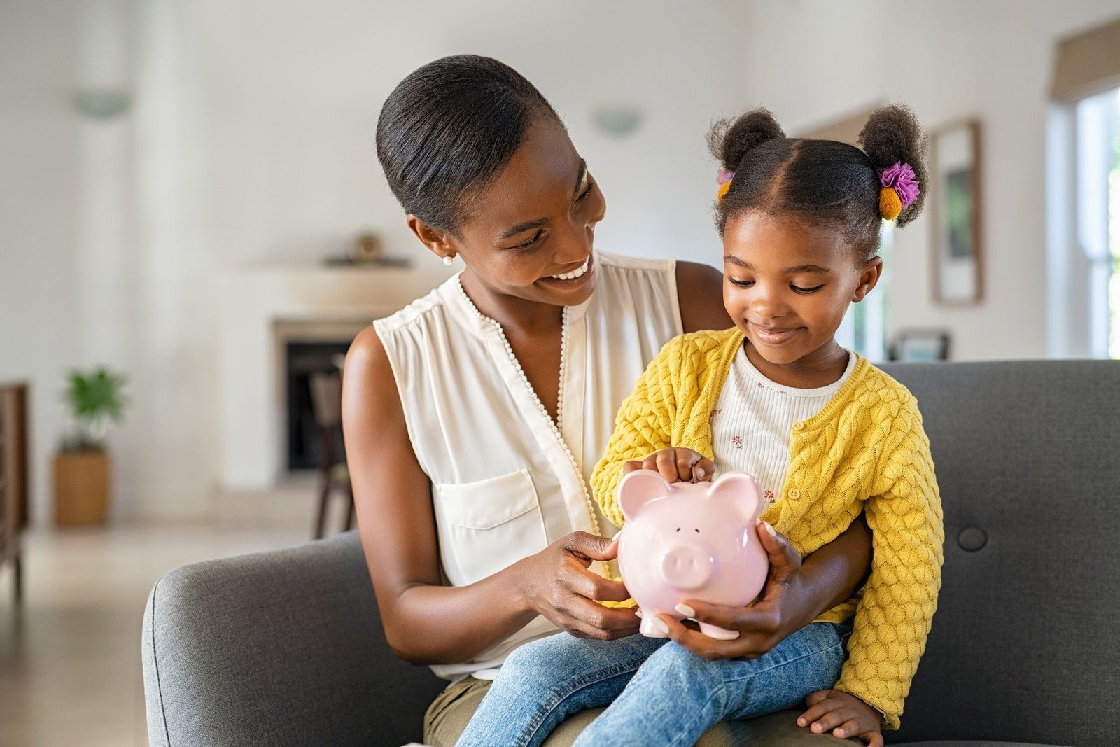A parent and her young daughter sitting together at home