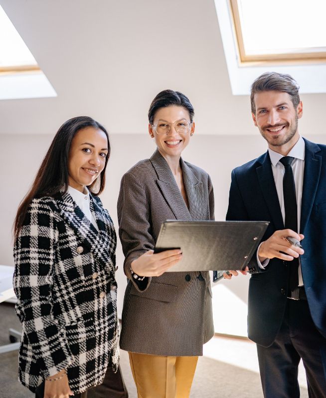 Three business professionals reviewing documents together